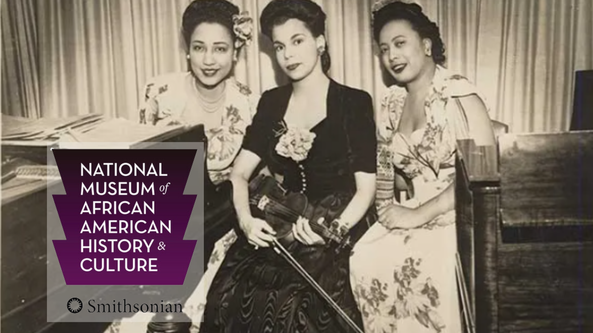 three African American women in a historical photo of a musical group lableled the Sepia Tones woman in center is holding a violin